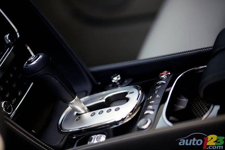 Hand-stitched leather surrounds the centre stack and shifter where the prestigious Bentley "B" waits your eager hand to push it into "D" -- so inviting. Photo: Sébastien D'Amour/Auto123.com