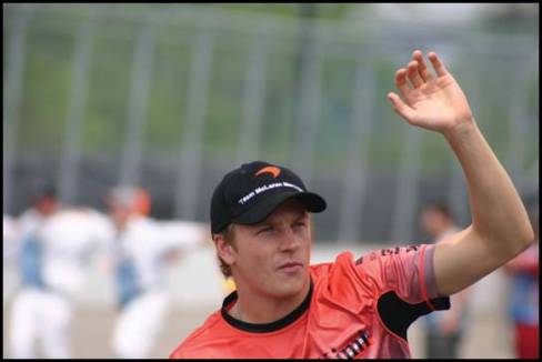During the same parade, future winner Kimi Räikkönen salutes the crowd around the circuit.
