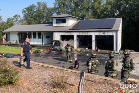 The burned Chevrolet Bolt EV, in front of the house