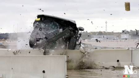 The Rivian pickup flies over a concrete barrier