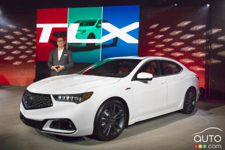 Jon Ikeda, Acura vice president and general manager, poses next to the new 2018 Acura TLX