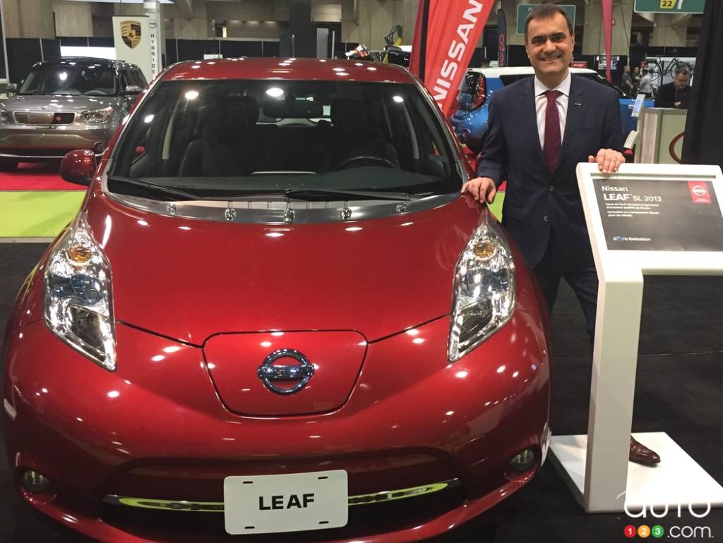 Joni Paiva, president of Nissan Canada Inc., stands next to a Qualified Pre-Owned LEAF