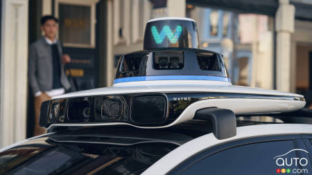 Traffic jam with four Waymo self-driving vehicles