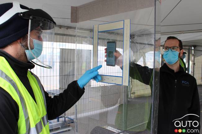 A worker showing his smartphone app at the FCA plant in Windsor, Ontario
