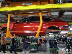 Plant staff working under the Impala on the assembly line