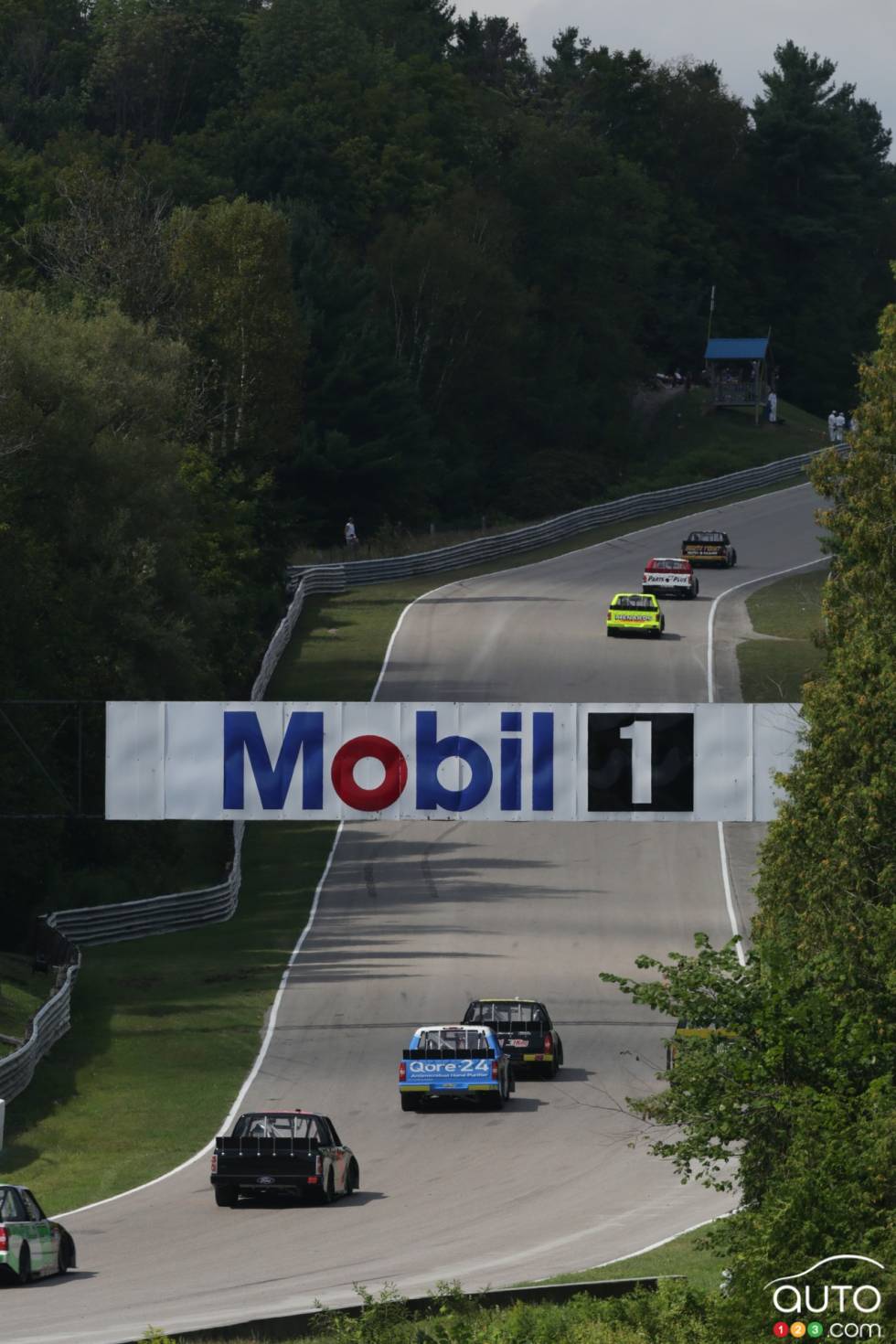 Field of trucks on the back strech in action during race