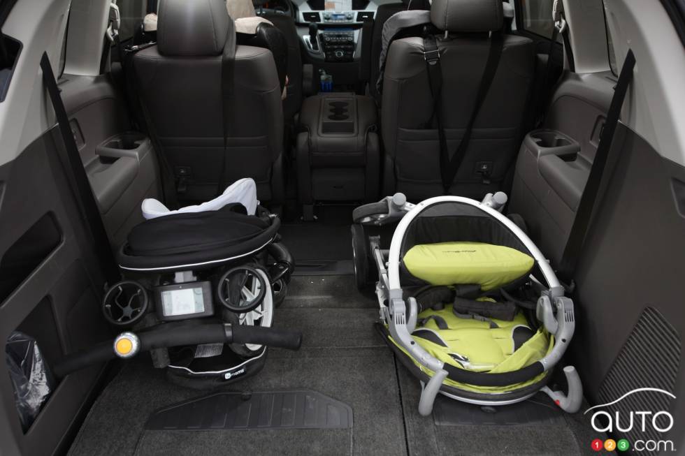 Two strollers in the cargo area with the third row seats folded down