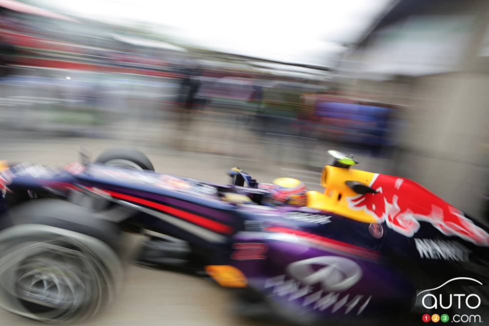 Mark Webber leaves his garage.