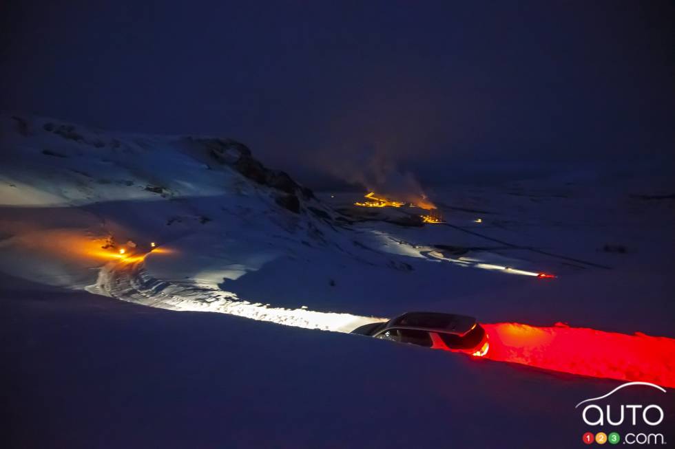 Trail of lights as the vehicles makes their way through snow banks