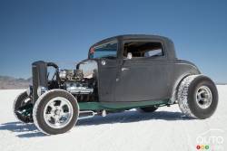 A 1932 Ford 3-window coupe hot rod in primer paint.