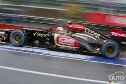 A Lotus car goes through pit lane