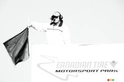 A flag man waves the green flag during the pre-race celebration.