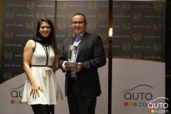 Maxime Surette, of Kia Canada, receives the Intermediate car of the year 2018 (Kia Stinger)Award